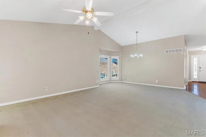 Dining area w/bay window has chandelier...wood floor entry foyer. — 18 Country Bluff Court, St Charles, MO 63301