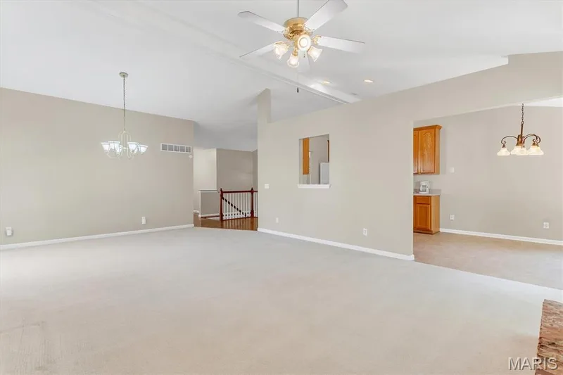 Vaulted, open living area has ceiling fan and opens to entry foyer and breakfast room. — 18 Country Bluff Court, St Charles, MO 63301