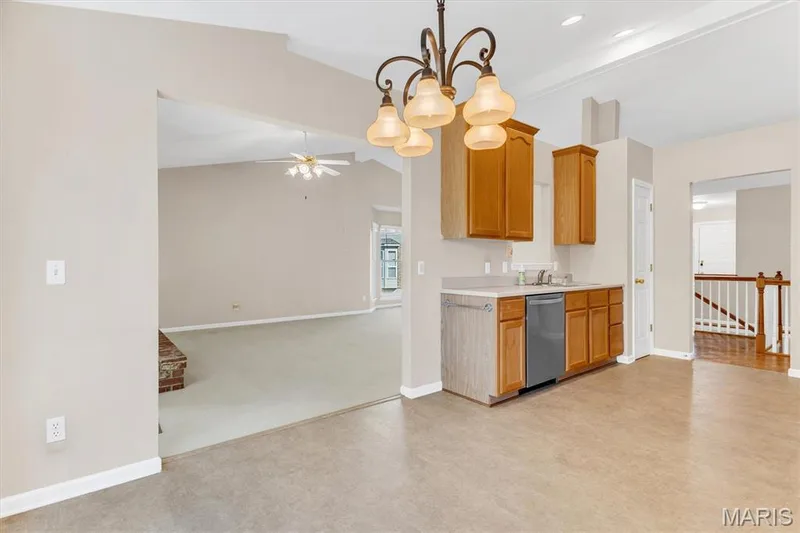 View from breakfast room to living area & kitchen (with pantry). — 18 Country Bluff Court, St Charles, MO 63301