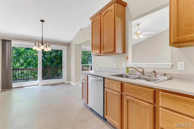 Breakfast room w/slider opens to deck & treelined view. — 18 Country Bluff Court, St Charles, MO 63301