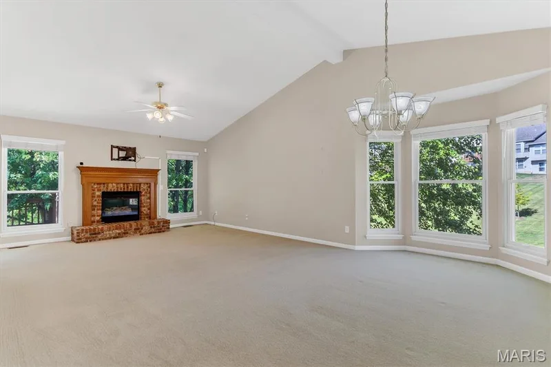 Vaulted, open living area w/gas log fireplace & bay window. — 18 Country Bluff Court, St Charles, MO 63301