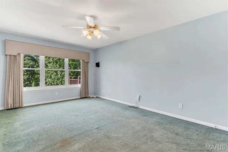 Primary main floor bedroom has ceiling fan. — 18 Country Bluff Court, St Charles, MO 63301