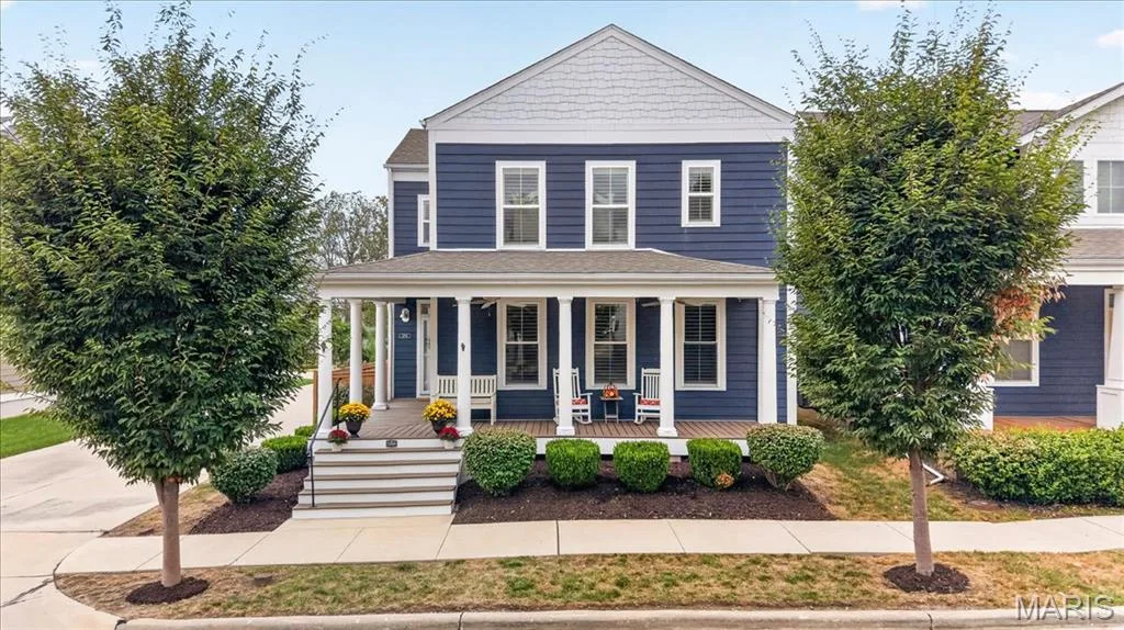 Two-story residence featuring blue siding with white trim, a covered front porch, and a gable roofline — 3708 Broad Street, St Charles, MO 63301