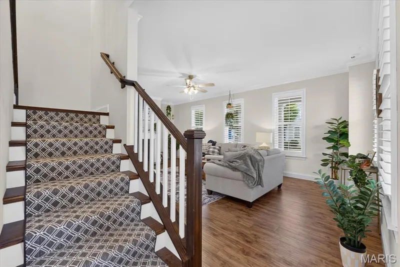 Hardwood flooring, painted interior walls, white trim, plantation shutters, and a ceiling fan — 3708 Broad Street, St Charles, MO 63301
