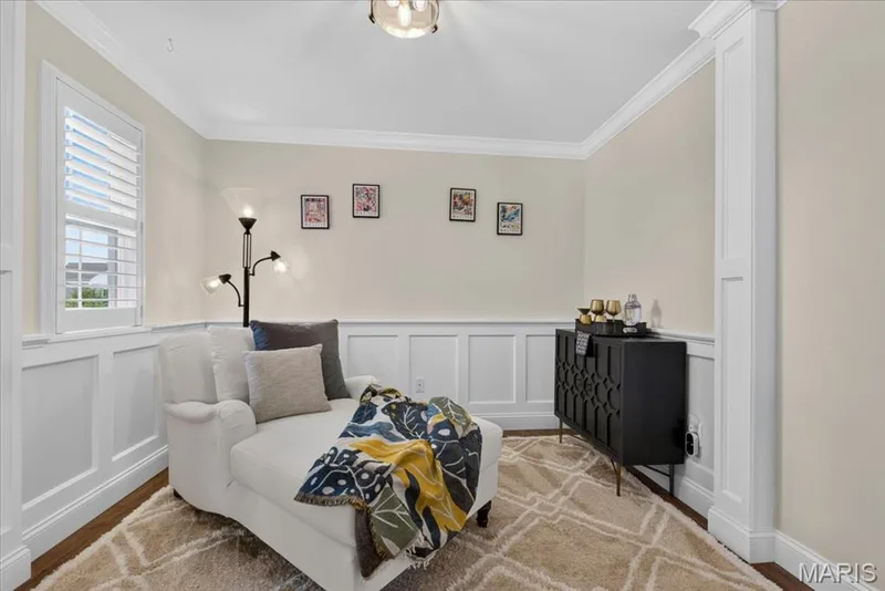Hardwood-finish flooring, white wainscoting, crown molding, plantation shutters, and a built-in ceiling light fixture — 3708 Broad Street, St Charles, MO 63301