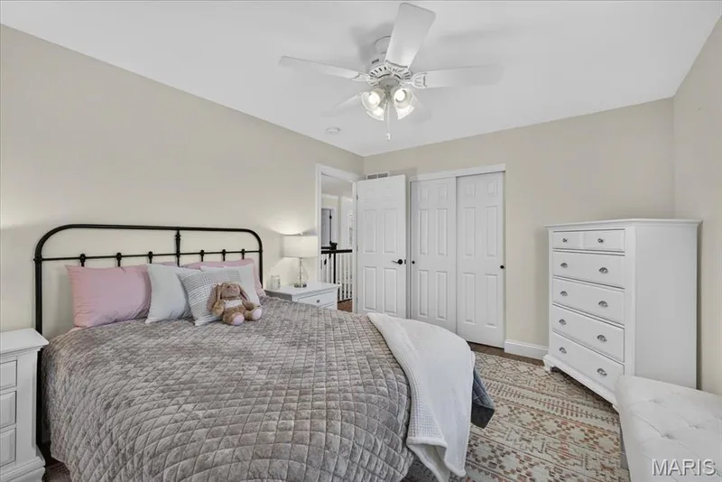Neutral wall tones, ceiling fan with integrated lighting, and white bi-fold closet doors — 3708 Broad Street, St Charles, MO 63301