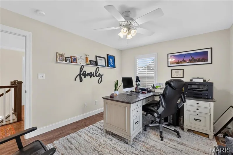 Wood-finish flooring, ceiling fan with light fixture, and window with plantation shutters — 3708 Broad Street, St Charles, MO 63301
