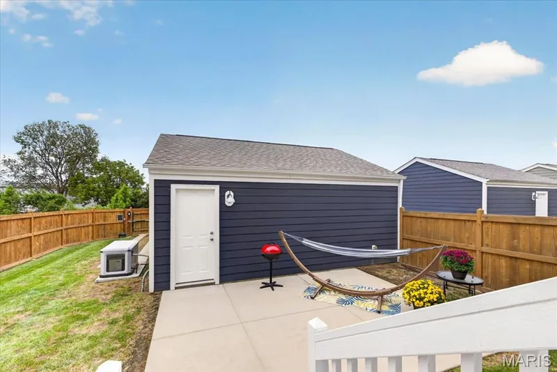 Detached structure with blue horizontal siding, white trim, and a shingled roof — 3708 Broad Street, St Charles, MO 63301