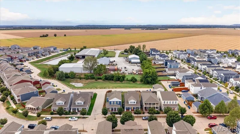 Residential neighborhood with diverse house styles, tree-lined streets, and paved roadways, bordered by expansive agricultural fields — 3708 Broad Street, St Charles, MO 63301