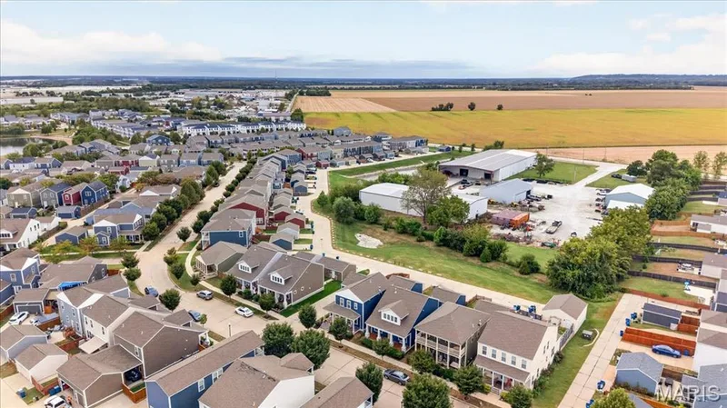 Residential development with a variety of architectural styles, bordered by mature trees and agricultural fields — 3708 Broad Street, St Charles, MO 63301