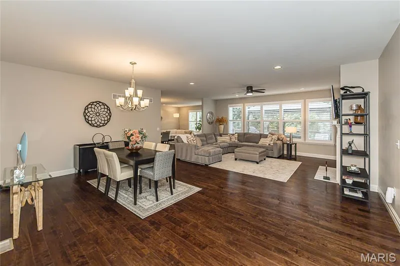 Expansive hard-surface flooring throughout, recessed lighting, and a modern chandelier — 1229 Cashmere Lane, St Peters, MO 63376