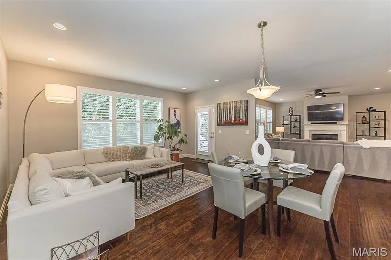 Hardwood-finish flooring, recessed lighting, and a dining area with a glass-top table — 1229 Cashmere Lane, St Peters, MO 63376