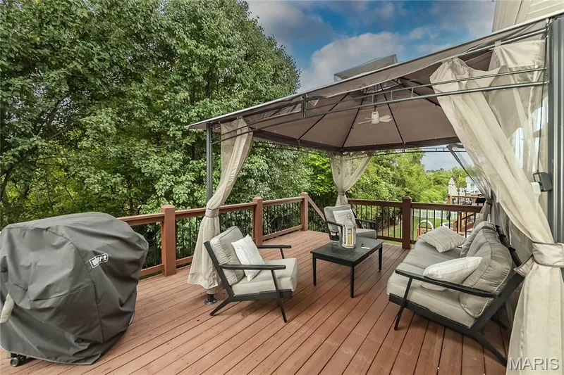 Expansive outdoor deck featuring wood-finish flooring and a gazebo with a ceiling fan — 1229 Cashmere Lane, St Peters, MO 63376