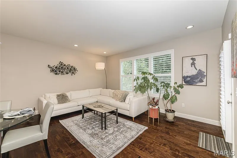 Recessed ceiling lighting, wood-finish flooring, white plantation shutters, and light-toned wall paint — 1229 Cashmere Lane, St Peters, MO 63376