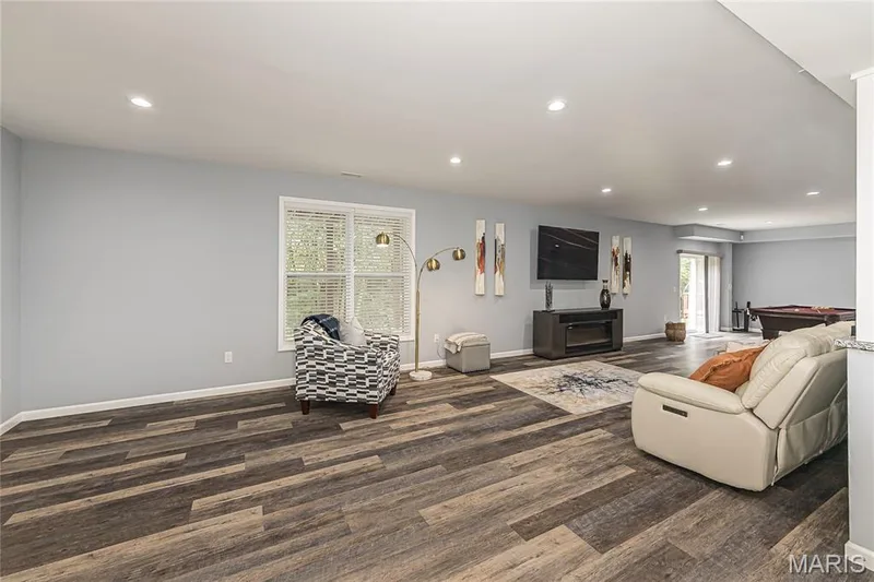 Recessed lighting, wood-finish flooring, light gray wall paint, window with blinds, and white trim — 1229 Cashmere Lane, St Peters, MO 63376