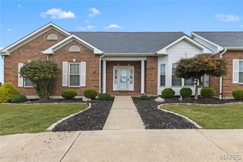 Brick exterior with white siding accents and a covered entry — 104 Wolf Trail Court, Defiance, MO 63341