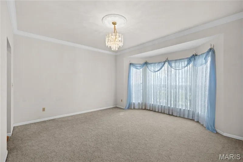 Recessed bay window, crown molding, chandelier with ceiling medallion, and carpeted flooring — 104 Wolf Trail Court, Defiance, MO 63341
