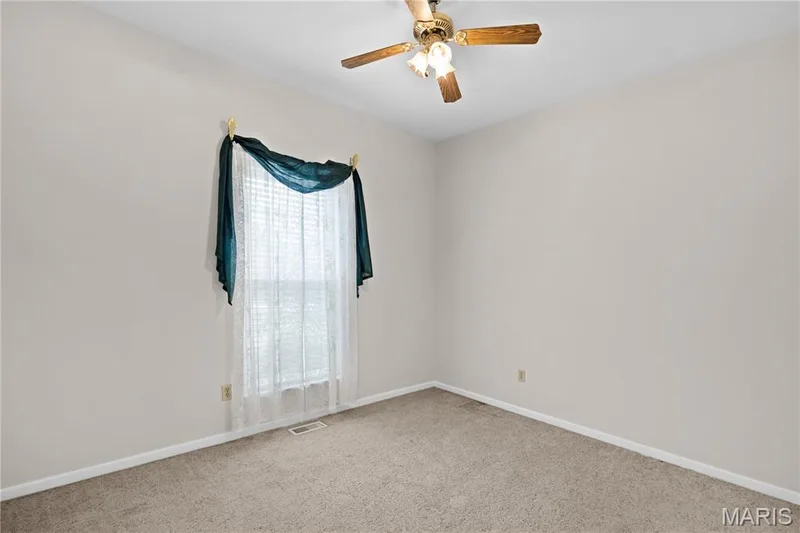 Neutral-toned walls, carpeted flooring, and a ceiling fan with integrated lighting — 104 Wolf Trail Court, Defiance, MO 63341
