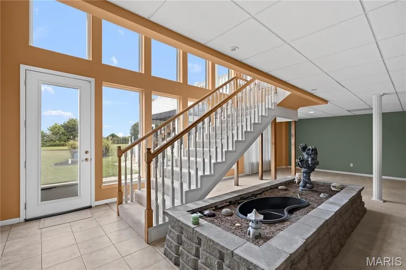 Expansive two-story window wall with multiple panes — 104 Wolf Trail Court, Defiance, MO 63341