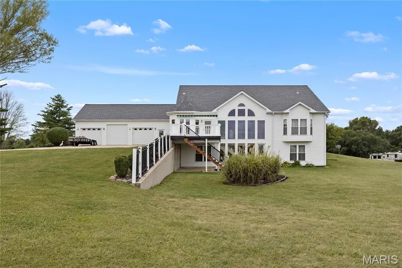 White exterior with a dark shingle roof and multiple gables — 104 Wolf Trail Court, Defiance, MO 63341