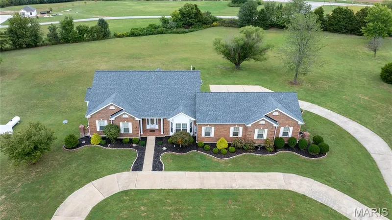 Brick exterior with white window shutters and a gray shingle roof — 104 Wolf Trail Court, Defiance, MO 63341