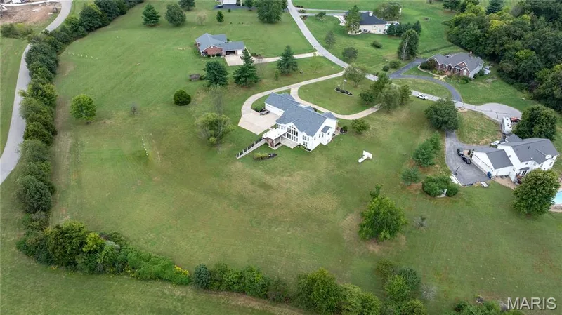Expansive green landscape with established trees and surrounding foliage — 104 Wolf Trail Court, Defiance, MO 63341