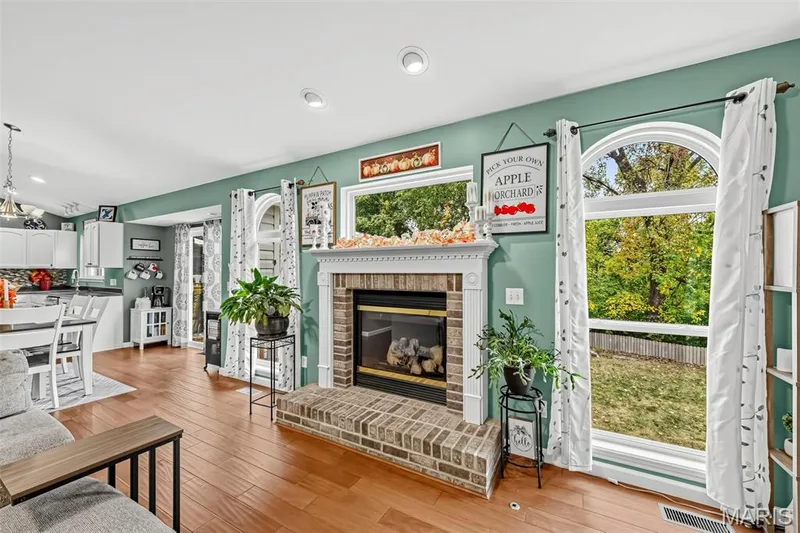 Gas fireplace flanked by 2 windows — 1840 Autumn Trail, Wentzville, MO 63385