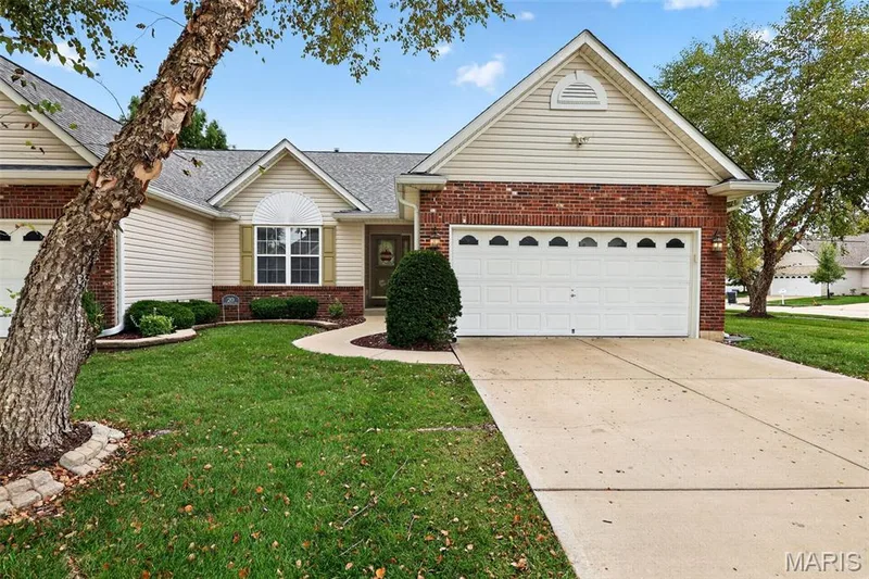 Brick and siding exterior with an attached two-car garage — 20 Autumn Ridge Drive #83B, O'Fallon, MO 63366