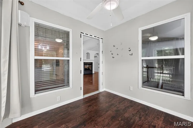 Wood-finish flooring, white ceiling fan, and multiple windows — 20 Autumn Ridge Drive #83B, O'Fallon, MO 63366