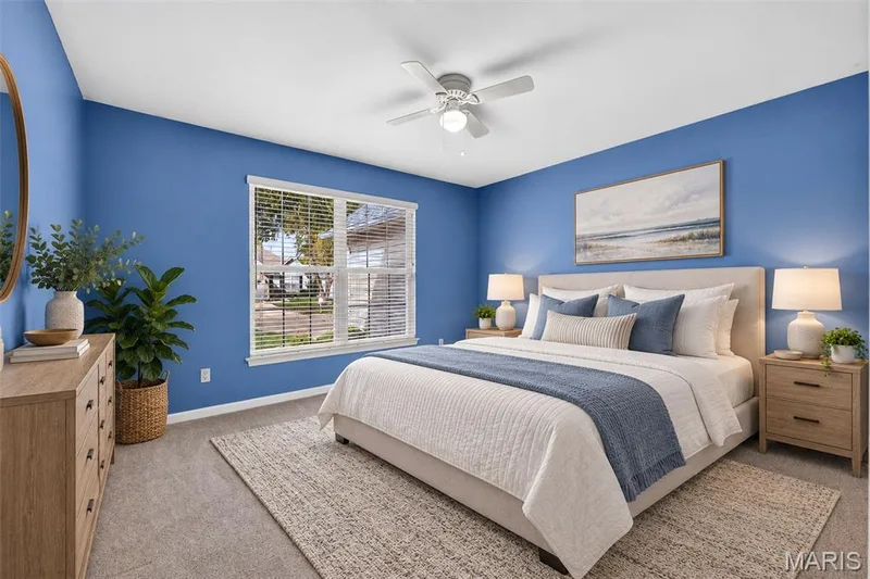 Vaulted ceiling, ceiling fan with integrated lighting, large window with blinds, plush carpeting, and built-in wall lighting — 20 Autumn Ridge Drive #83B, O'Fallon, MO 63366