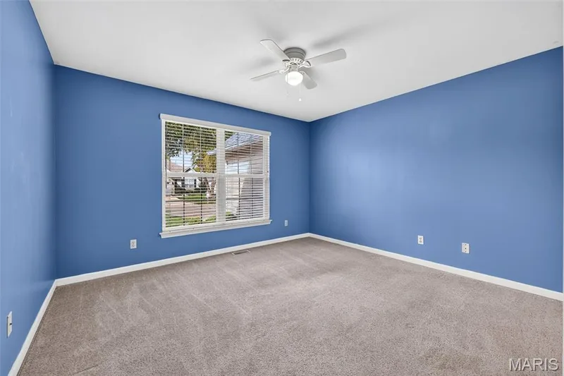 Wall-to-wall carpeting and a ceiling fan with integrated lighting — 20 Autumn Ridge Drive #83B, O'Fallon, MO 63366