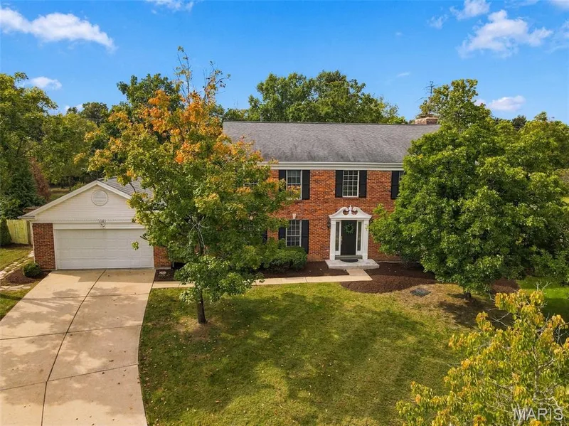 Brick exterior with white trim, a gabled roof, and a two-car garage — 2785 Sun Meadow Drive, Wildwood, MO 63005