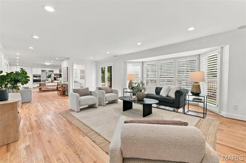 Recessed lighting, wood-finish flooring, bay window with plantation shutters, French doors, and an open-concept layout — 2785 Sun Meadow Drive, Wildwood, MO 63005