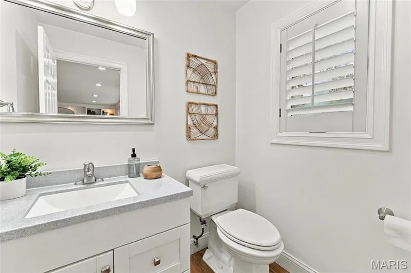 White single vanity with a light-colored countertop and undermount sink — 2785 Sun Meadow Drive, Wildwood, MO 63005