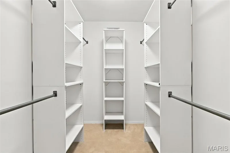 Walk-in closet featuring built-in shelving, adjustable shelves, and garment rods — 2785 Sun Meadow Drive, Wildwood, MO 63005