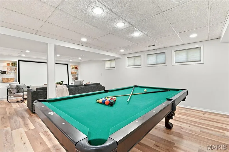 Spacious recreation area featuring wood-finish flooring, recessed lighting, and built-in shelving — 2785 Sun Meadow Drive, Wildwood, MO 63005