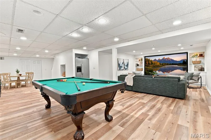 Recessed lighting, wood-finish flooring, built-in shelving, stainless steel refrigerator, and double panel doors — 2785 Sun Meadow Drive, Wildwood, MO 63005
