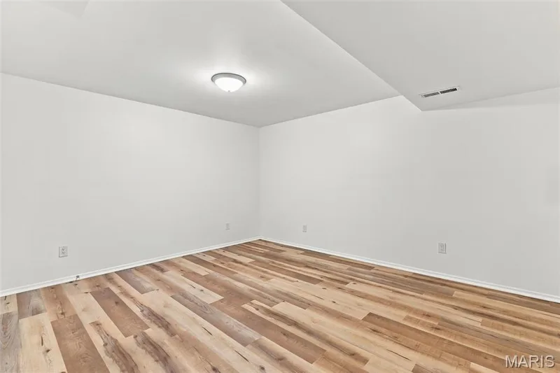 Recessed and flush-mount ceiling lighting illuminates wood-finish flooring — 2785 Sun Meadow Drive, Wildwood, MO 63005
