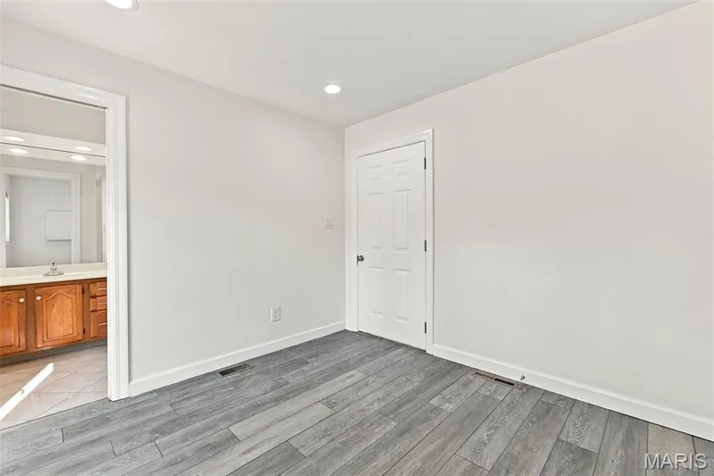 Recessed lighting, wood-finish flooring, and white interior doors — 2785 Sun Meadow Drive, Wildwood, MO 63005