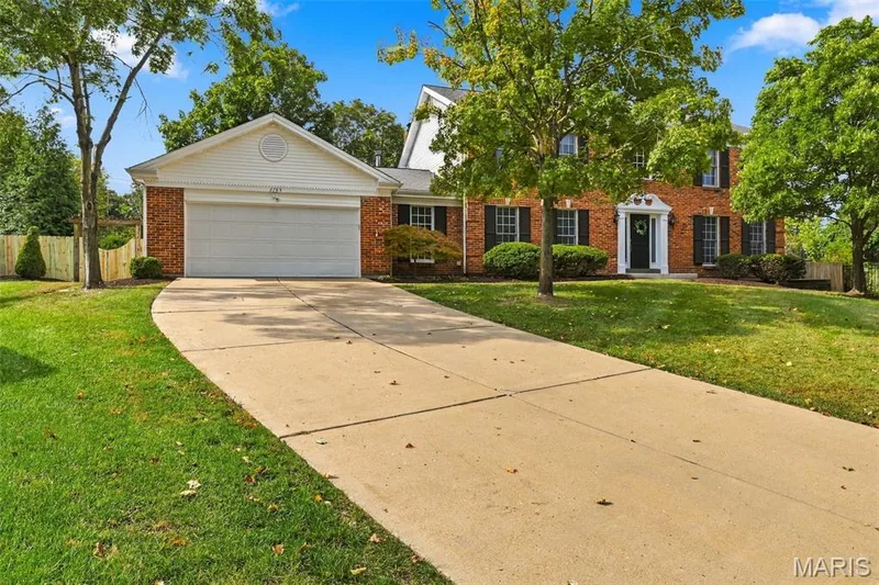 Brick exterior with white trim, a two-car garage, and a concrete driveway — 2785 Sun Meadow Drive, Wildwood, MO 63005