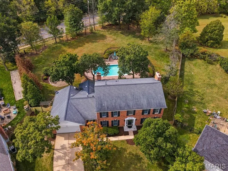 Brick exterior residence with a shingle roof, attached garage, and a paved driveway — 2785 Sun Meadow Drive, Wildwood, MO 63005