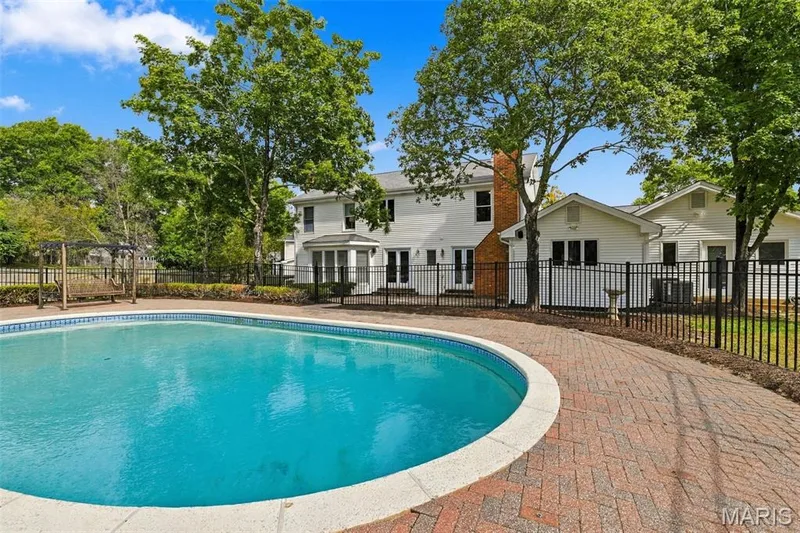 In-ground swimming pool with brick paver surround and wrought iron fencing — 2785 Sun Meadow Drive, Wildwood, MO 63005