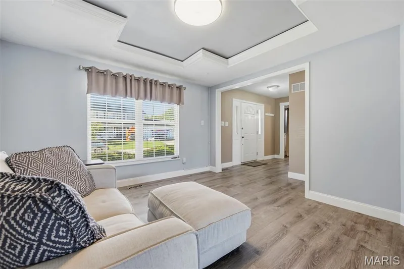 Living Room with tray ceiling with inset crown molding; adjoins Foyer and Hearth Room. — 386 Beckley Place, St Charles, MO 63304