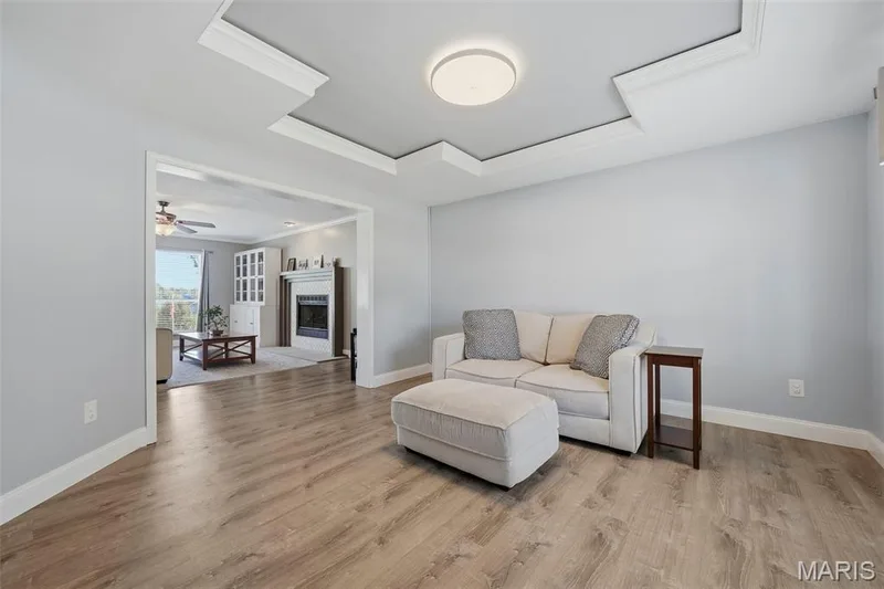 Living Room with tray ceiling with inset crown molding; adjoins Foyer and Hearth Room. — 386 Beckley Place, St Charles, MO 63304