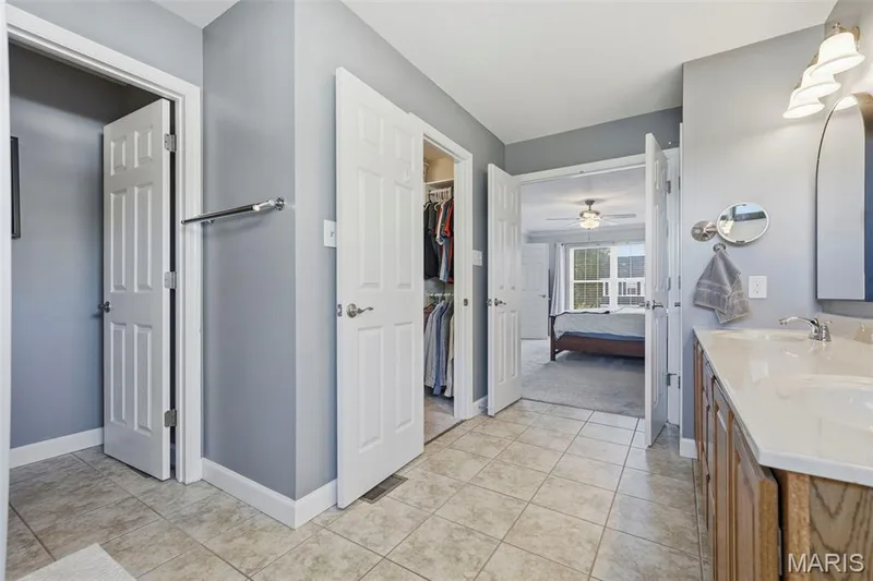 En Suite Primary Bathroom with double vanities, jet tub, shower, and water closet. — 386 Beckley Place, St Charles, MO 63304