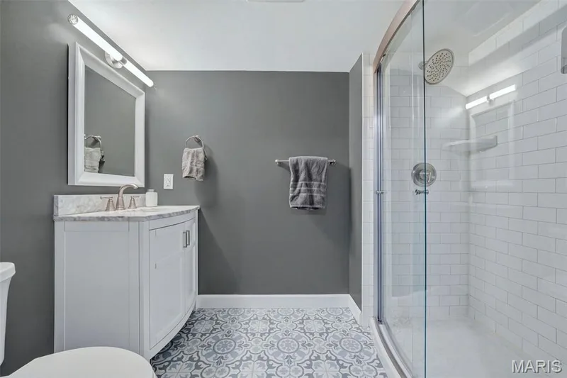 Lower-Level Full Bath with custom tile floor and shower with subway tile surround. — 386 Beckley Place, St Charles, MO 63304