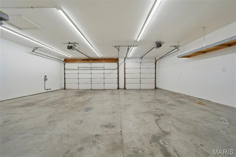 Fully insulated/drywalled and heated/cooled, oversized 3 car garage (29' x 20') with Workshop (21' x 9'), LED lighting, and EV ready charging station; door to Mudroom with Laundry and exterior door to rear deck. — 386 Beckley Place, St Charles, MO 63304