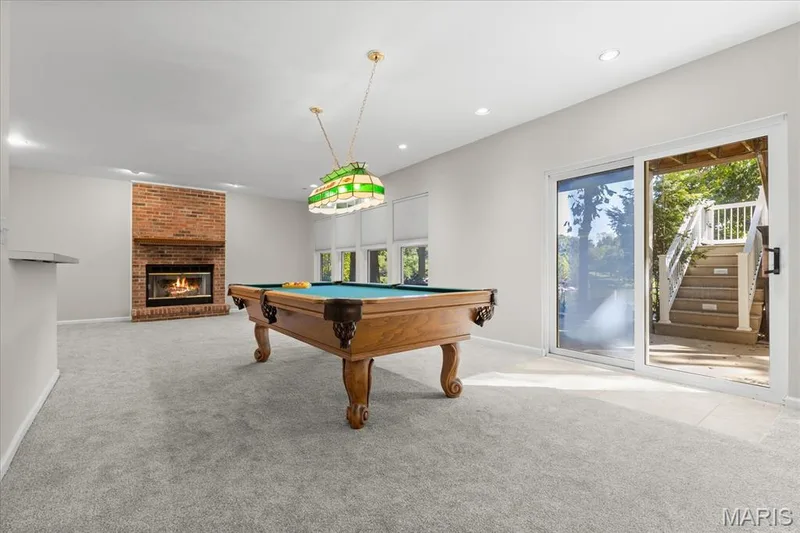 Recreation room with another fireplace and walkout to the patio — 16 Regatta Bay Court, Lake St. Louis, MO 63367