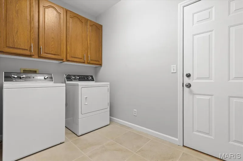 Main floor laundry room with access to 3 car garage — 16 Regatta Bay Court, Lake St. Louis, MO 63367