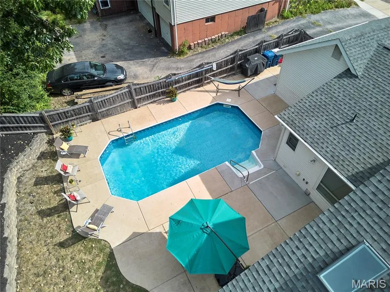 In-ground swimming pool with surrounding concrete patio — 1843 Shadywood Court, Chesterfield, MO 63017